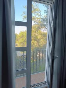 an open window with a view of a balcony at Hotel Toruño del Rocío in El Rocío