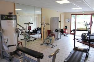 a gym with a lot of exercise equipment in a room at Village Club Le Saint Ignace in Ascain