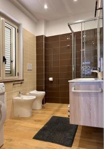 a bathroom with a toilet and a sink and a shower at Bilocale31 - stile e comfort a Frascineto in Frascineto