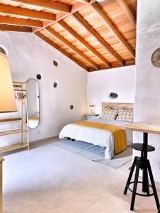 a bedroom with a bed and a desk in it at Casas Javier in Adeje