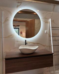 a bathroom with a sink and a mirror at Cottage - A Casa da Avó in São Vicente +46 photos