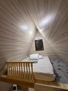 a small room with a bed in a tent at Miman house Kolsay in Kurmenty