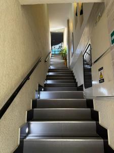 a long staircase in a building with grey steps at DUSANO BOUTIQUE HOTEL in Santa Marta