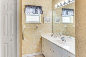a bathroom with a sink and a mirror at 5 Mi to Sebring Intl Raceway Canal-View Retreat! in Sebring +17 photos