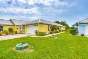 a house with a yard with a frisbee at 5 Mi to Sebring Intl Raceway Canal-View Retreat! in Sebring