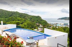 a villa with a swimming pool overlooking the ocean at Tropical Views - Luxury Live #The Best Views #Walk to The Beach in San Juan del Sur