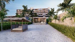 a resort on the beach with a hotel in the background at Shah Palace Zanzibar - All Suites in Matemwe