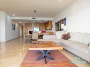 a living room with a couch and a table at Playa Blanca Premier Unit 1302 in San Carlos