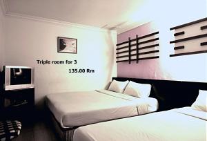 Ein Bett oder Betten in einem Zimmer der Unterkunft Hotel China Town 2