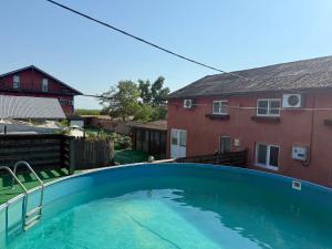 a swimming pool in the backyard of a house at Pensiunea Bibi in Crisan