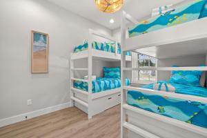 a room with two bunk beds with blue pillows at Brand New Home with In-ground Pool, Four Houses From Beautiful Laguna Beach in Laguna Beach +52 photos