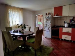 a kitchen with a table and chairs in a kitchen at Bukuljska kuća in Arandjelovac