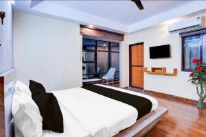 a bedroom with a large bed and a desk at Golden M Riz Hotel & Restuarant in Lucknow