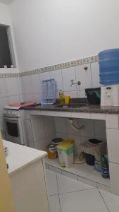 a small kitchen with a counter and a counter top at Kitnet jardim Campomar in Rio das Ostras +2 photos
