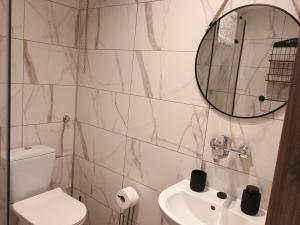 a bathroom with a toilet and a sink and a mirror at Chata Pod Różą in Lędzin
