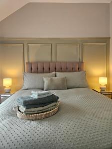 a bed with a bunch of towels on it at Harding Haven in Derry Londonderry