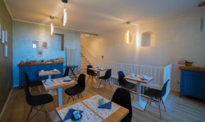 a restaurant with tables and chairs and a staircase at BIXIO40 BED&BREAKFAST and APARTMENTS in Montefiascone