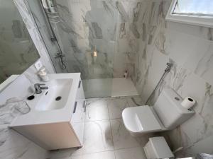 a bathroom with a sink and a toilet and a shower at Trebol 1 in Costa Del Silencio +26 photos