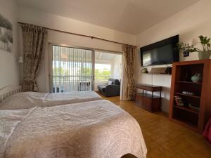 a bedroom with a large bed and a television at Trebol 1 in Costa Del Silencio +49 photos