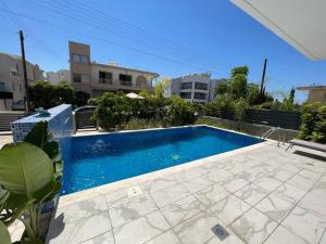a swimming pool in the middle of a yard at Modern 3 bedroom villa with pool in Paphos City