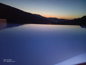 a large body of water with the sunset in the background at Celini villa Tinos in Krokos
