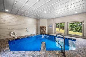 a swimming pool in a home with a ceiling at The King Of The Mountain - 6617 Sq Ft sleeps 22 amazing mountain views, Private Indoor Pool in Sevierville