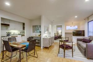 a kitchen and a living room with a couch and a table at Beryl Bungalow in San Diego +16 photos