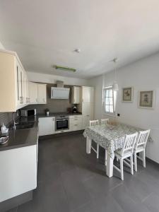 a kitchen with a table and a table and chairs at Apartamento Celma in Adeje