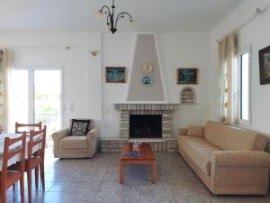 a living room with a couch and a fireplace at Villa Maria in Agia Anna