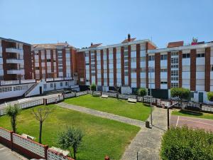 a park in the middle of a city with buildings at Apartamento Playa de Ber in Puentedeume +16 photos
