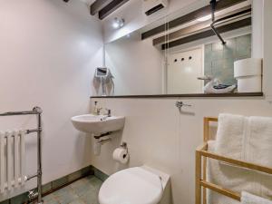 a bathroom with a toilet and a sink and a mirror at 6 Bed in Martindale 95344 in Patterdale +36 photos