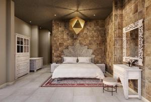 a bedroom with a large bed and a mirror at Shah Palace Zanzibar - All Suites in Matemwe +16 photos