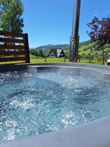 a jacuzzi tub with water in it at Domki Na Brzyzku - Domek w górach z balią z jacuzzi in Zakopane