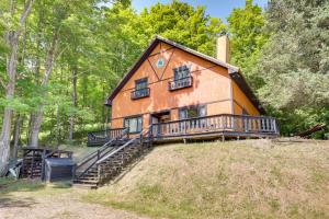 a house on top of a hill with trees at Outdoor Lovers Paradise Slope-View Cabin! in Iron River