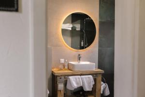 a bathroom with a sink and a mirror at Pe Dealul Mieilor in Măguri +18 photos