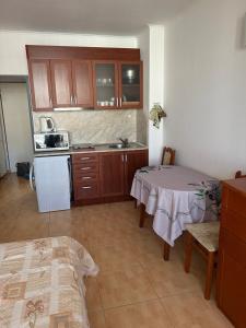 a small kitchen with a table and a stove at Central Plaza Apartment in Sunny Beach
