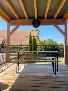 a picnic table on a deck with a view of a building at Le RiedExpress in Schwobsheim