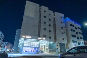 a building with a car parked in front of it at Afaq Al Marsa Hotel in Al Madinah