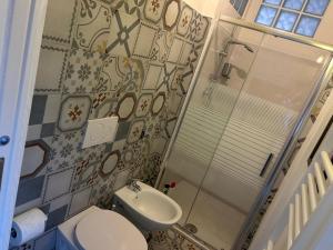a bathroom with a shower and a toilet and a sink at Casa Maria Antonia in Rapone