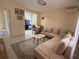 a living room with a couch and a table at Vacation Home Kondi Ilia in Petran