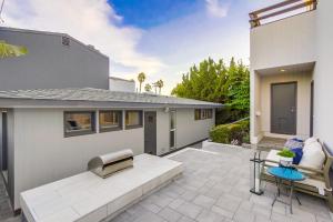 a patio of a house with a bench and a table at Beryl Bungalow in San Diego