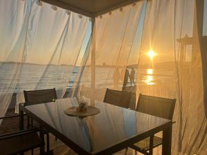 a table and chairs with a view of the ocean at Villa Kiara in Vodice