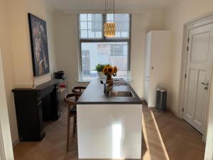 a kitchen with a sink and a counter top at Stadslogement No 11-13 in Harderwijk