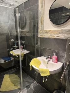 a bathroom with a sink and a shower at Haus Monika - wunderschöne ruhige Wohnung in Fürstenfeldbruck