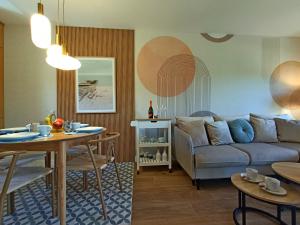 a living room with a couch and a table at Na Pokładzie e-apart in Jastrzębia Góra