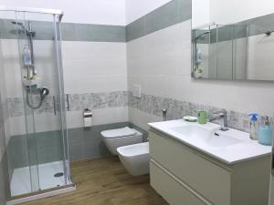 a bathroom with a toilet and a sink and a shower at Room private Ossi in Ossi +4 photos