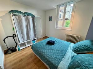 a bedroom with a bed and a window at PERLE RARE centre-ville in Paray-le-Monial