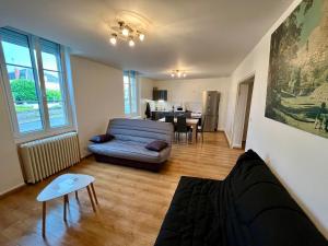 a living room with a couch and a table at PERLE RARE centre-ville in Paray-le-Monial