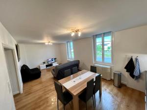 a living room with a table and a couch at PERLE RARE centre-ville in Paray-le-Monial