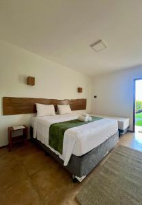 a bedroom with a large bed in a room at Bosque Cumbuco Pousada in Cumbuco +101 photos